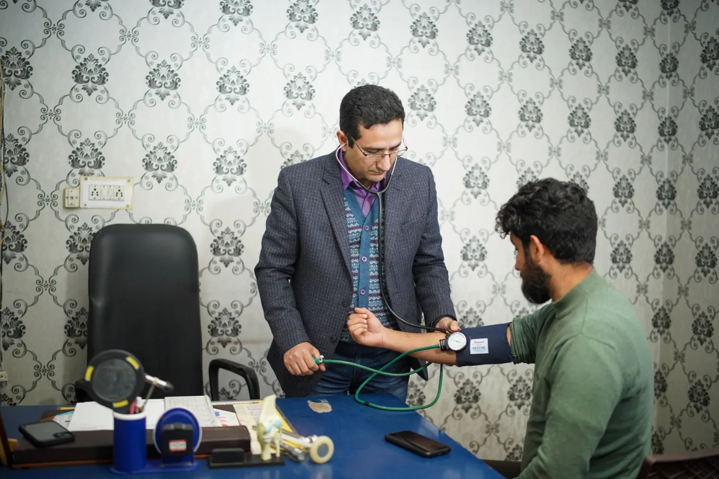 A clinician talking with a patient in a consultation room