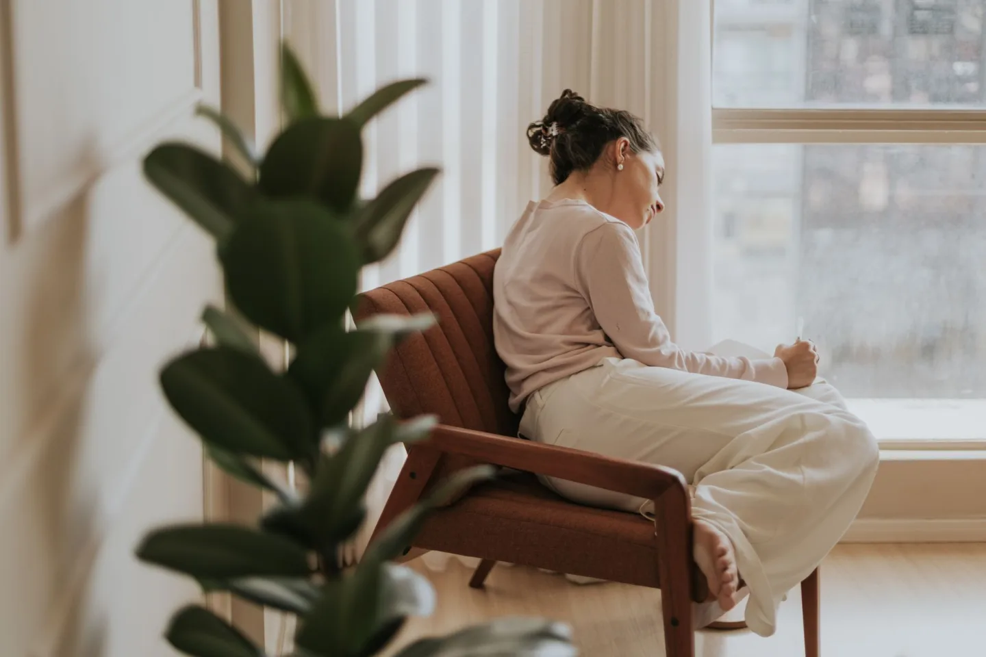 A parent pausing in thought at home