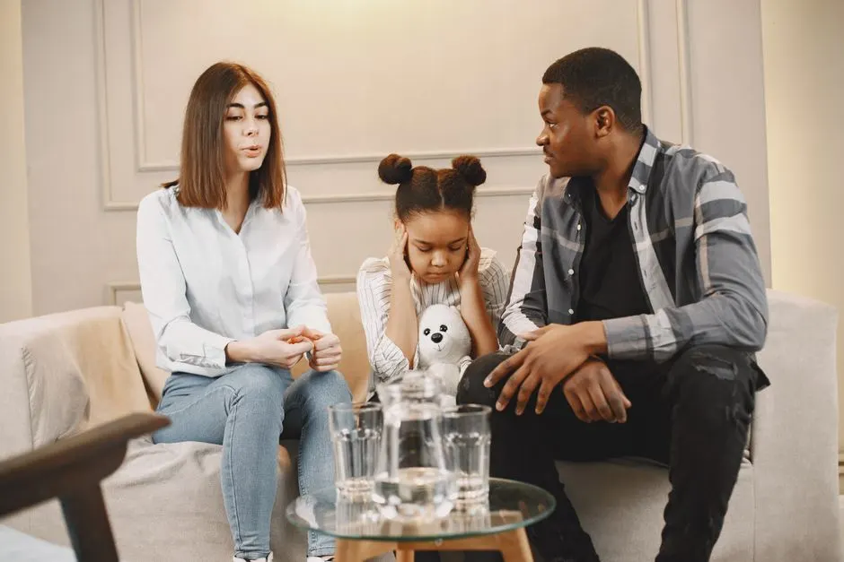 A newcomer family talking quietly together at home